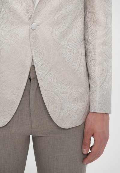 Light gray blazer with a swirling textured pattern, single button closure, and a tailored fit, paired with a light brown textured pant.
