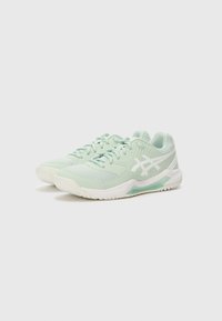 Light mint green athletic shoes with a textured mesh upper, white synthetic accents, and a cushioned sole featuring a transparent section.