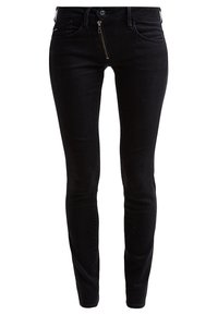 Black denim skinny jeans with a front zipper, slim fit, five-pocket design, and subtle stitching details. Smooth texture, minimal accents.