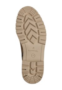Tan rubber shoe sole with a deep tread pattern, featuring raised zigzag and horizontal lines for grip. Marked with brand logo and size.