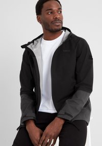 Black and gray waterproof jacket with a hood, featuring a zip front, adjustable cuffs, and subtle branding on the chest and shoulder.