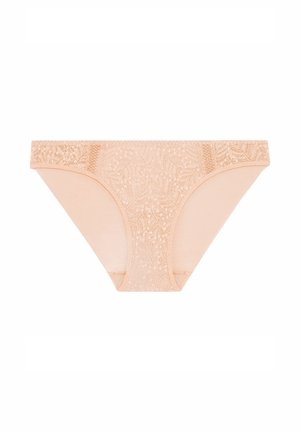Naadloze kant thong in nude met florale patroondetail, gemaakt van een zachte stof. De tailleband is afgewerkt met verfijnde kant. Naadloze zijkanten voor extra comfort.