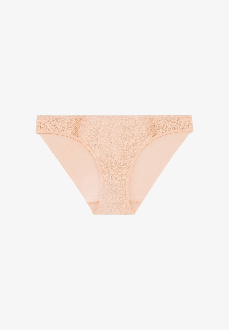 Nude spetsstring med blommönster, tillverkad av mjukt tyg. Midjebandet pryds av detaljerad spetskant. Sömlösa sidor för komfort.