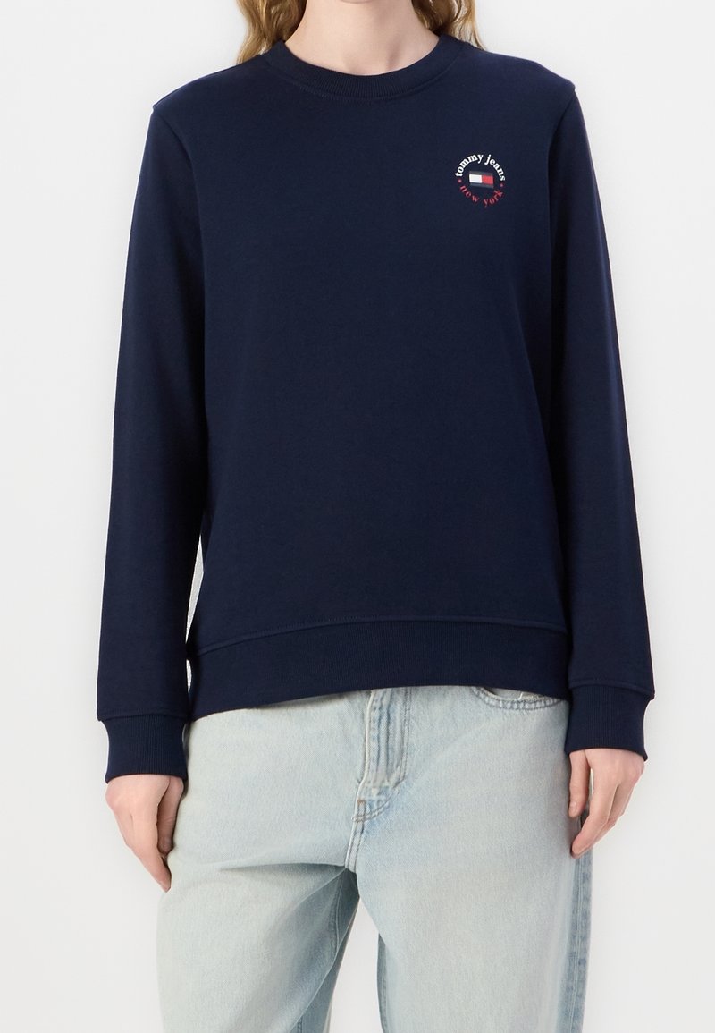 Navy blue sweatshirt in cotton blend, featuring a crew neck, long sleeves, and small logo detail on the chest. Soft texture and relaxed fit.