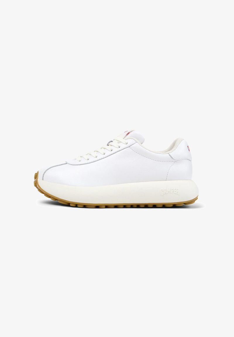 White leather sneaker with a rounded design, featuring a thick, beige rubber sole and textured accents. Minimalistic lacing and branding detail.