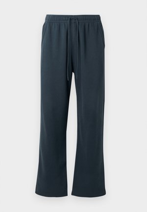 Pantalones de chándal gris oscuro, hechos de un tejido suave y elástico. Cuentan con una cinturilla elástica con cordón ajustable y piernas anchas.
