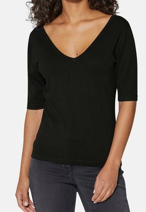 Schwarzes V-Ausschnitt-Oberteil aus weichem Stoff, mit kurzen Ärmeln und einer figurbetonten Passform, die dem Körper folgt. Einfacher und minimalistischer Stil.