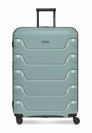 Hellgrüner Hartschalenkoffer mit vier Rollen, einem schwarzen Teleskopgriff und horizontalen, strukturierten Rillen auf der Vorderseite.