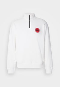 White pullover sweatshirt made of soft material, featuring a half-zip collar, ribbed cuffs, and a red circular logo on the left chest.