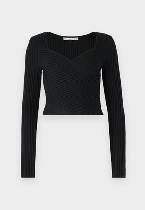 Top corto nero con maniche lunghe, caratterizzato da una texture a coste e un design incrociato sul davanti. Tessuto liscio, stile minimalista.