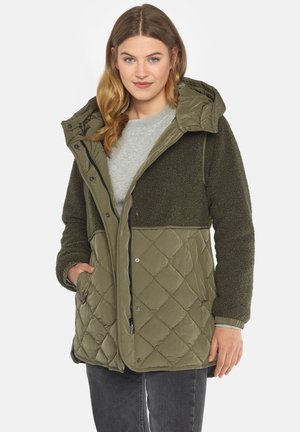 Olive green quilted jacket with a soft, textured fleece upper, detachable hood, snap closure, and side pockets. Quality fabric and stitching details.