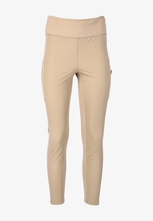 Beige leggings tillverkade av stretchigt tyg med en bred midja, som har sidofickor och minimal sömdetalj. Slät textur genom hela plagget.