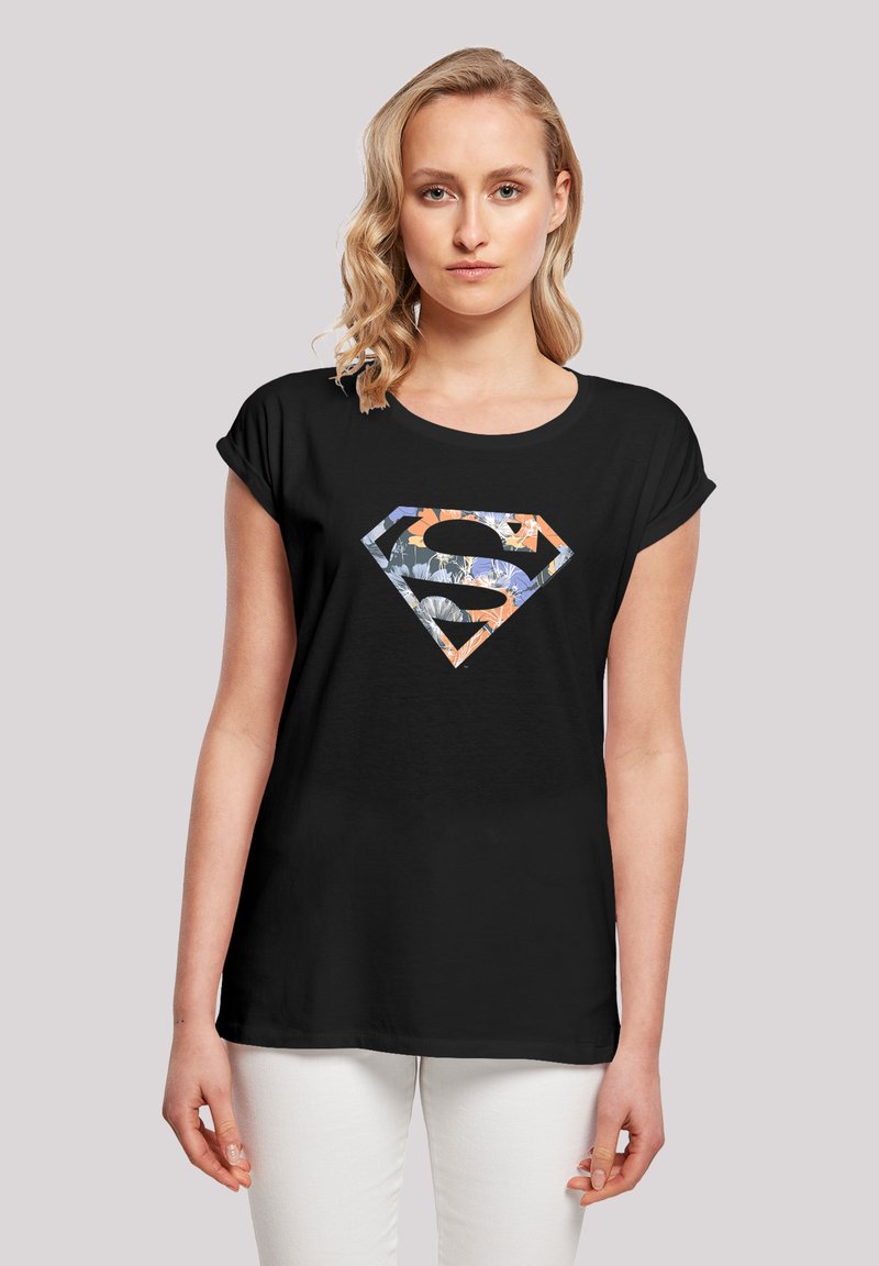 Black short-sleeve t-shirt featuring a multicolored floral Superman logo in a diamond shape at the center. Lightweight fabric, relaxed fit.