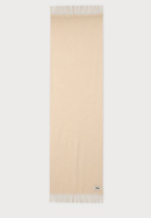 Beige rectangular wool scarf with fringed edges and a small branded label near one fringe end.