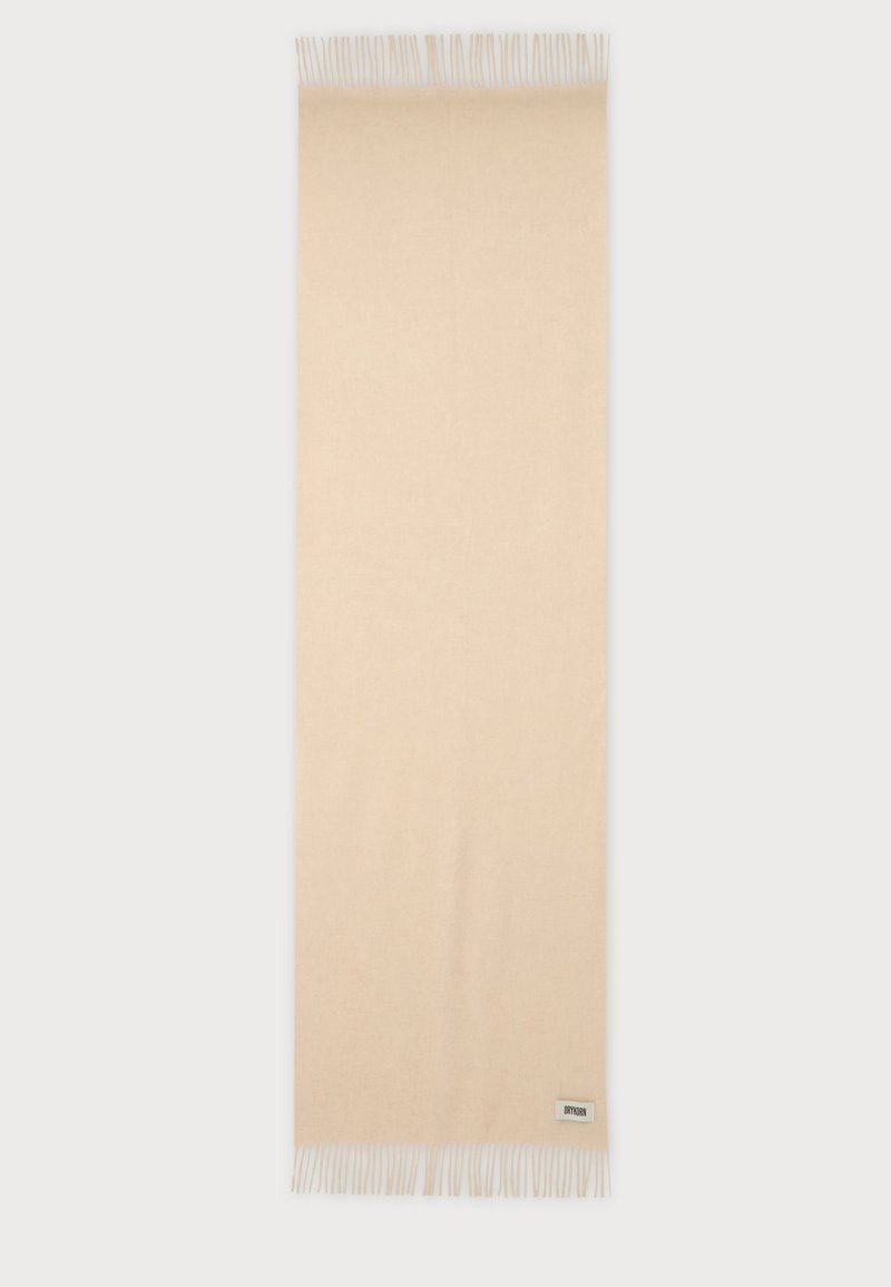 Écharpe rectangulaire en laine beige avec des bords à franges et une petite étiquette de marque près d'une extrémité à franges.