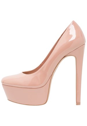 Lśniący, cielisty lakierowany czółenko na platformie z wysokim obcasem w szpilce i zaokrąglonym noskiem, zaprezentowane z boku na białym tle.