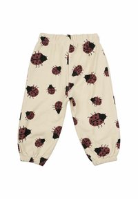 Krém színű nadrág piros és fekete katicabogár mintázattal, rugalmas derékkal és ráncolt szárakkal a bokánál. Puha tapintású.