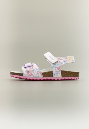 Παιδικό λευκό σανδάλι με πολύχρωμα καρικατούρα πρόσωπα σκύλων, ρυθμιζόμενα λουράκια, πάτο φελλού και ροζ λαστιχένια σόλα, πλευρική άποψη.