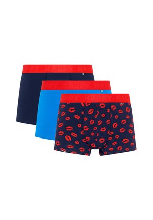 Three pairs of men's boxer briefs with red waistbands; one navy with red lip prints, one solid blue, and one solid navy.