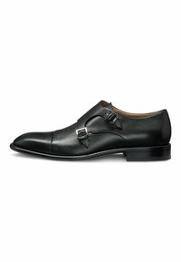 Svart läder monk strap-sko med en elegant, spetsig tå, dubbla silverfärgade spännen och en slät, glänsande finish. Gummisula.