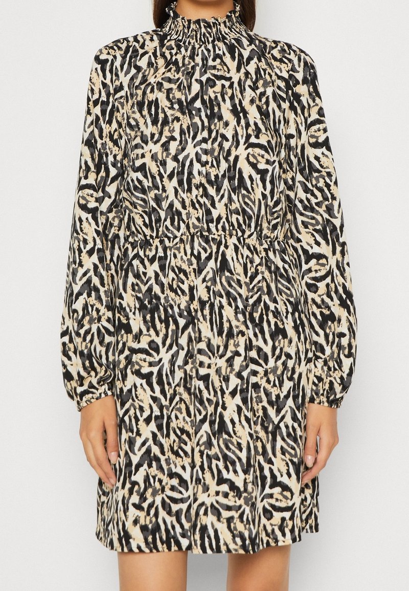 Long-sleeve dress with a high smocked neck, featuring a beige and black abstract animal print pattern. Lightweight fabric with a relaxed fit.