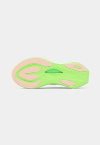 Sole of a shoe featuring a green rubber outsole with a wavy pattern, complemented by pink accents and textured grooves for grip.