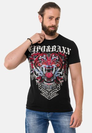 Schwarzes T-Shirt mit einem bunten Tiger-Graphic und detaillierten Mustern. Das Material scheint Baumwolle zu sein; eng anliegendes Design mit kurzen Ärmeln und Rundhalsausschnitt.