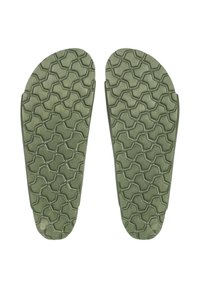 Green rubber shoe soles with a textured hexagonal pattern, featuring rounded edges and circular indentations at the heel.