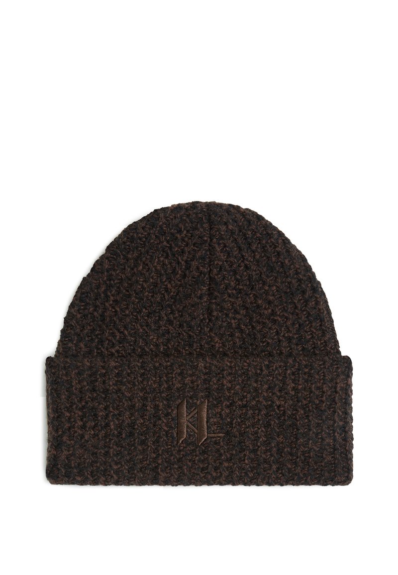 Knitted beanie in dark brown with a textured weave. Features a folded cuff and embossed logo on the front. Measures approximately 10 inches high.