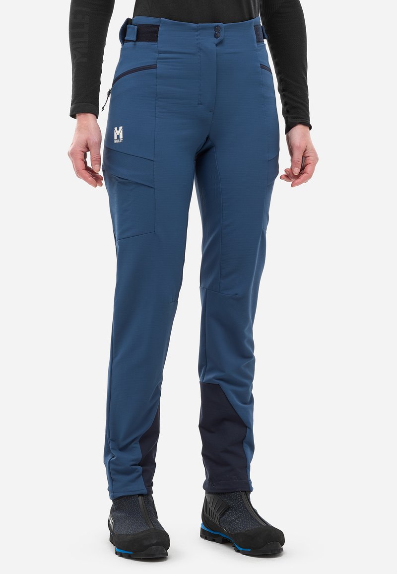 Pantalons techniques de plein air bleus avec une coupe ajustée, dotés de poches latérales, d'une taille haute et d'accents navy contrastants au bas des jambes.