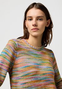 Multicolored striped knit sweater with a round neckline, featuring vibrant hues of pink, green, blue, and yellow, crafted from soft yarn.