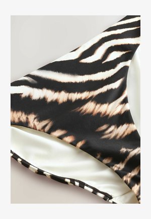 Bikini donji dio u crno-bež tigrovom uzorku s glatkom teksturom, koja sadrži kontrastnu unutarnju podstavu i šivane rubove.