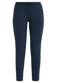 Marinblå mjukisbyxor med dragsko i midjan, två framfickor och avsmalnande ben. Tillverkade av mjukt, stretchigt tyg.