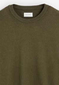 Suéter de punto verde oliva con cuello redondo, que presenta un logo sutil en el pecho. Textura suave con un corte clásico.