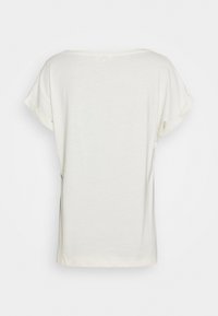 T-shirt court blanc cassé à manches courtes avec des ourlets roulés, vu de dos sur un fond blanc.