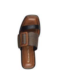 Svart och brun slidesandal med en flätad rem och en stor spänneaccent. Har en fyrkantig tå och en strukturerad innersula.