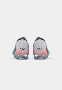 Football boots with a grey upper, turquoise accents, pink gradients, and a transparent sole. Features a black logo on the heel.