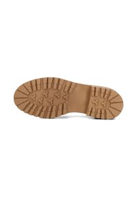 Brown rubber shoe sole with deep treads and ridges for traction. Textured surface features geometric patterns and printed "Made in Spain."