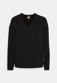 Czarny sweter dziany z dekoltem w serek, długimi rękawami i prążkowaną fakturą. Z przodu niewielka metka przy dolnym brzegu.