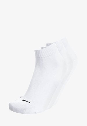 Three pairs of white ankle socks with ribbed cuffs and a small black logo near the toes, stacked in a staggered arrangement.