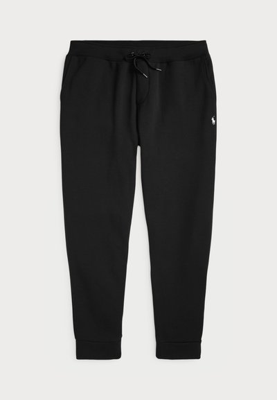 Black sweatpants made of soft cotton blend, featuring an elastic waistband with drawstring and ribbed ankle cuffs. Small logo on the side.