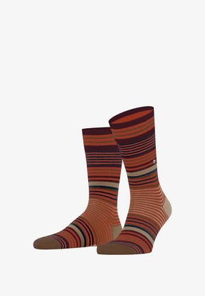 Calze a righe con colori vivaci come arancione, marrone e blu navy, realizzate in tessuto a maglia con motivi orizzontali a contrasto e una consistenza liscia.