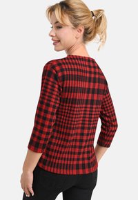 Roter und schwarzer karierten Pullover mit rundem Ausschnitt und Dreiviertelärmeln, mit weicher Textur und entspanntem Sitz.