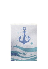 Cotton beach towel featuring a large blue anchor design on a white background with aqua wave patterns and fringed edges.