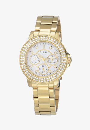 Montre dorée avec un cadran rond blanc, trois sous-cadrans, accents en cristal sur la lunette, et un bracelet en métal poli.