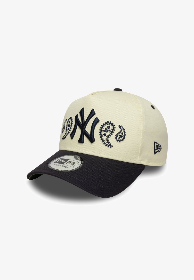 Cream cap with navy bill, featuring embroidered NY logo and paisley patterns. Made from fabric with a structured design, adjustable fit.