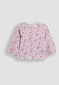 Langärmliges Oberteil aus weißem Stoff mit einem floralen Muster in Pink, Lila und Grün. Verfügt über einen runden Ausschnitt und geraffte Ärmel.