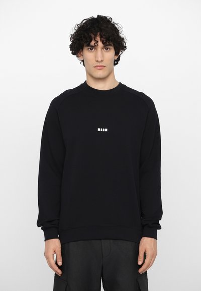 Sweatshirt noir à manches longues et ourlet côtelé, arborant le logo blanc "MSGM" sur la poitrine. Fabriqué en doux mélange de coton.