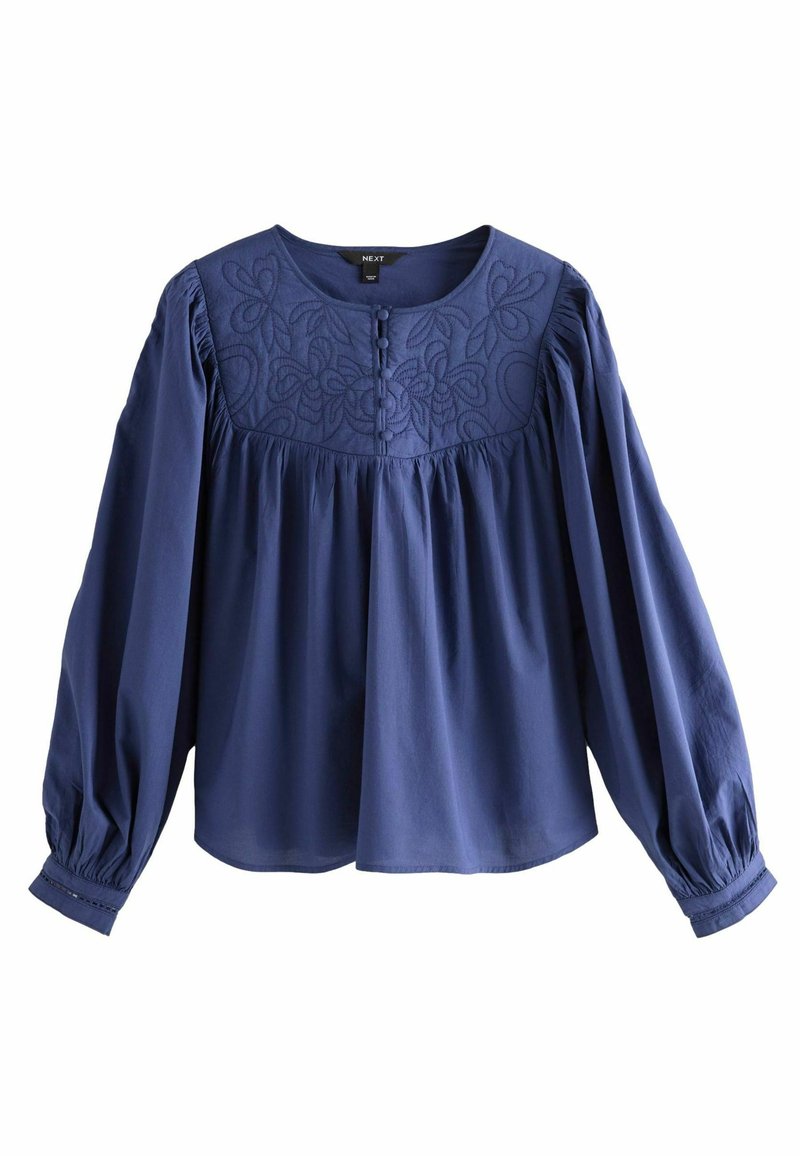 Blouse bleu marine avec des manches longues froncées, design floral brodé à l'avant et détails de boutons. Fabriquée en tissu doux et léger.