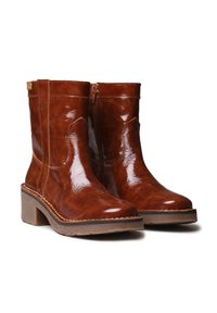 Brown leather ankle boots with a glossy finish, rounded toe, and side zipper. Chunky heel and contrast stitching detail.